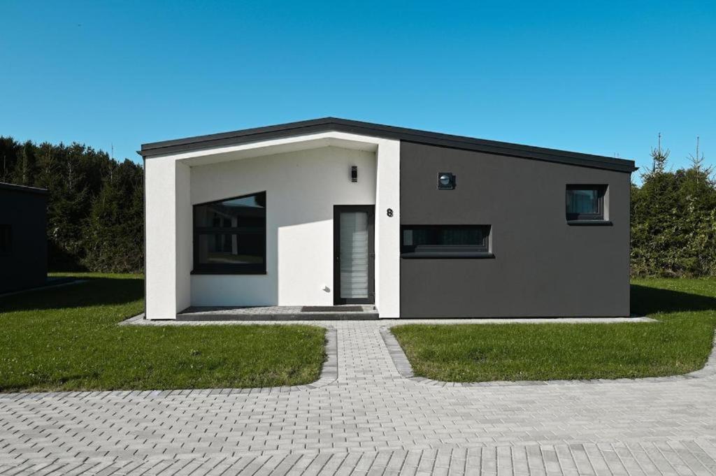 a small house with a driveway in front of it at Mini Kintų Perlas - Private Bungalow Complex in Kintai