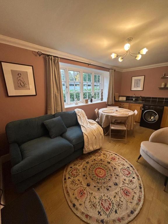 a living room with a couch and a table at The Snug in Goodrich