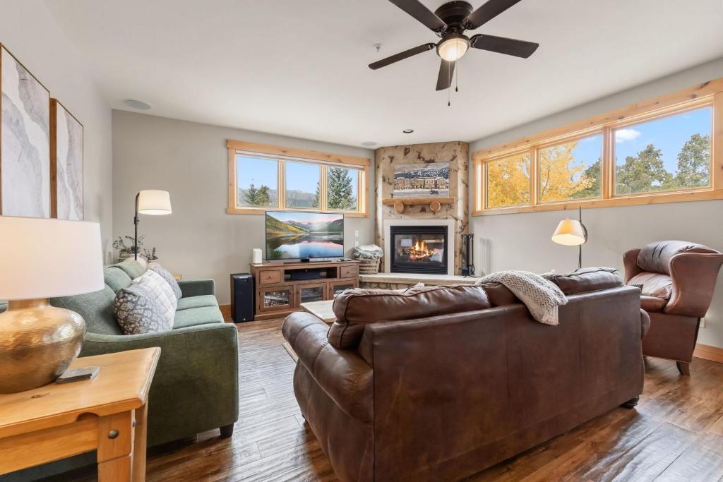 a living room with a couch and a tv at Walk to Main Street Hot Tub Gym and Game Room in Breckenridge