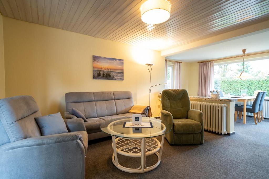 a living room with a couch and chairs and a table at Haus Sonnenwinkel Ina in Dahme