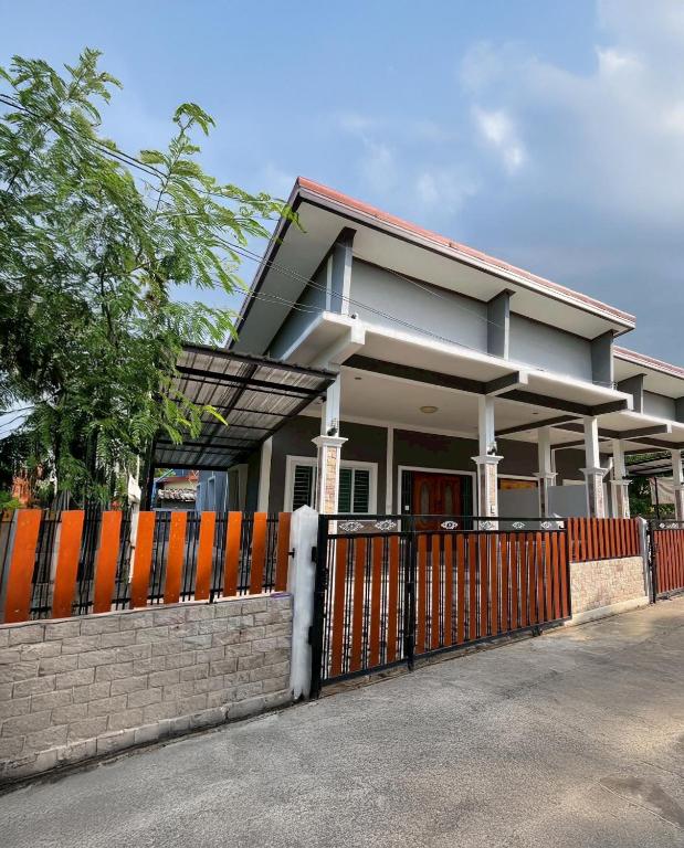 a house with a fence in front of it at I'm Home Narathiwat in Narathiwat