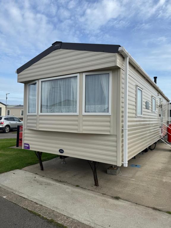 a mobile home is parked in a parking lot at Steph's Haven in Skipsea