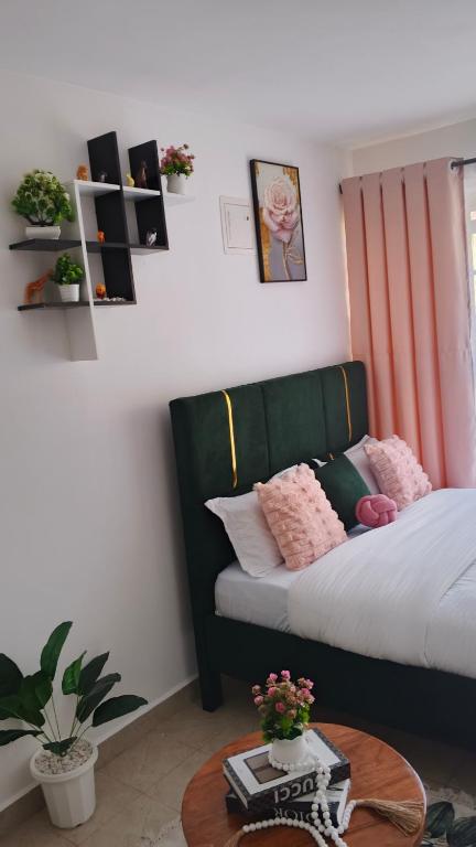 a bedroom with a bed and a coffee table at Budget bliss4 bnb Ruaka in Ruaka