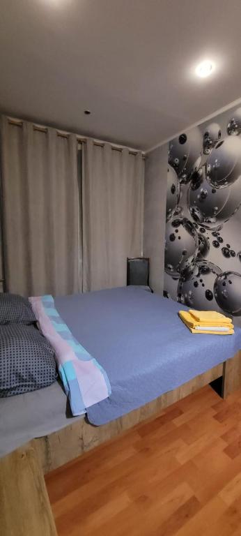 a bedroom with a large bed in a room at Saules line in Daugavpils