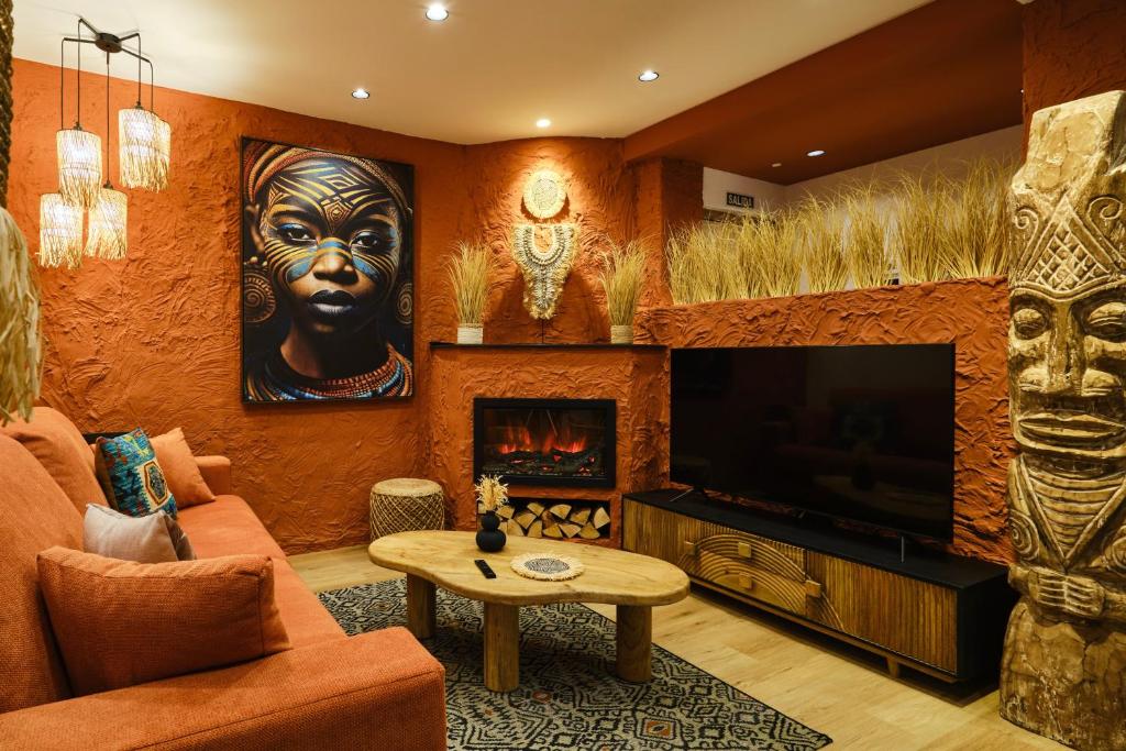 a living room with a tv and a fireplace at El Samburu - Apartamento boutique tribu africana - Grupo Querbes in Gijón