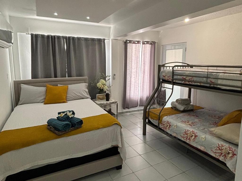 a bedroom with two bunk beds in a room at Casa Fortuna Near Luquillo Beach & El Yunque in Luquillo