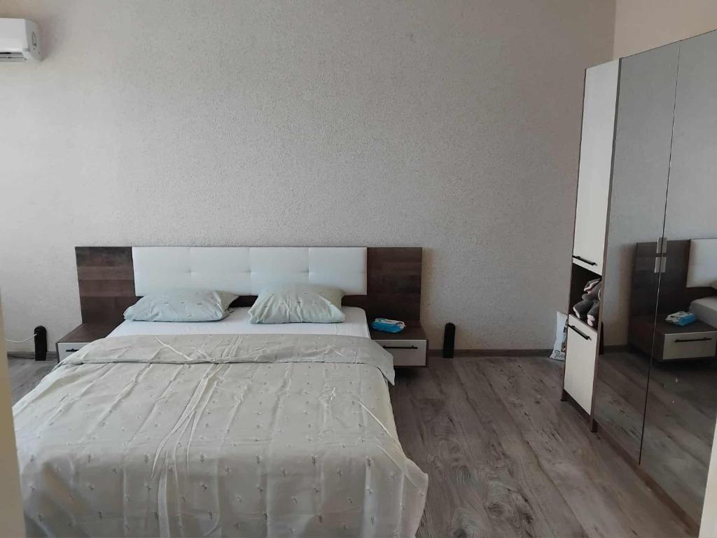 a bedroom with a large bed and a large mirror at Tedy in Oryakhovo