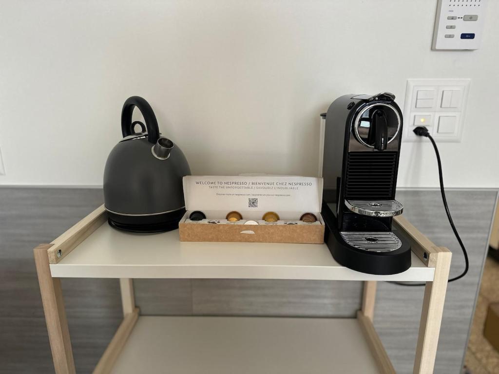 a coffee maker and a box of donuts on a table at Bergstudio II I Flims I Laax I Ski I Caumasee in Flims