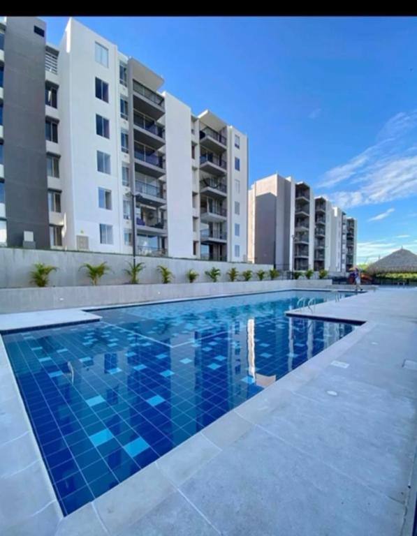 a swimming pool in front of some apartment buildings at Condomio Alicante Bahia Solero in Ricaurte