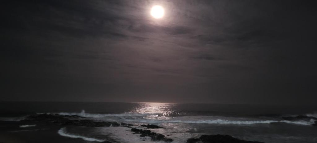 a full moon over the ocean at night at Sunseaker- Beachfront Complex in Ballito