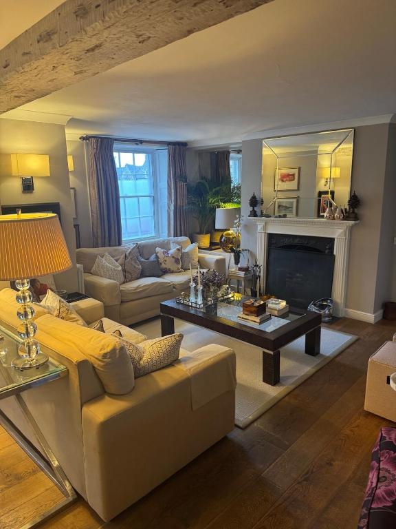 a living room with a couch and a table at Vine House in Tetbury