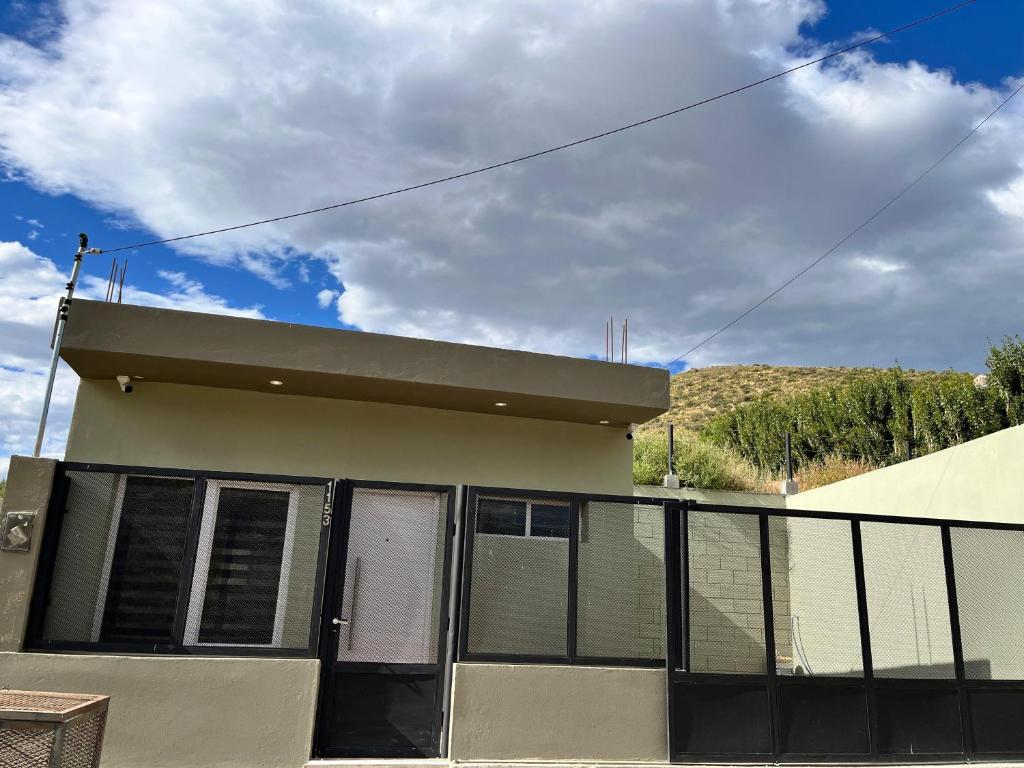a house with a fence in front of it at Atardecer Aparts in Escalante