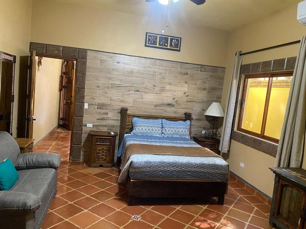 a bedroom with a bed and a couch at Marlin Suite - Walk to Beach & Town in Loreto