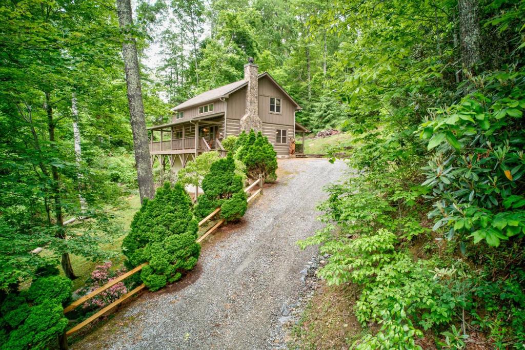 a home in the woods with a gravel driveway at Kaylee's Kabin in Vilas