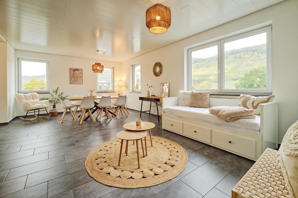 a living room with a couch and a table at Charmantes Ferienhaus an der Mosel mit Garten, Weinbergblick & Privatparkplatz in Zeltingen-Rachtig