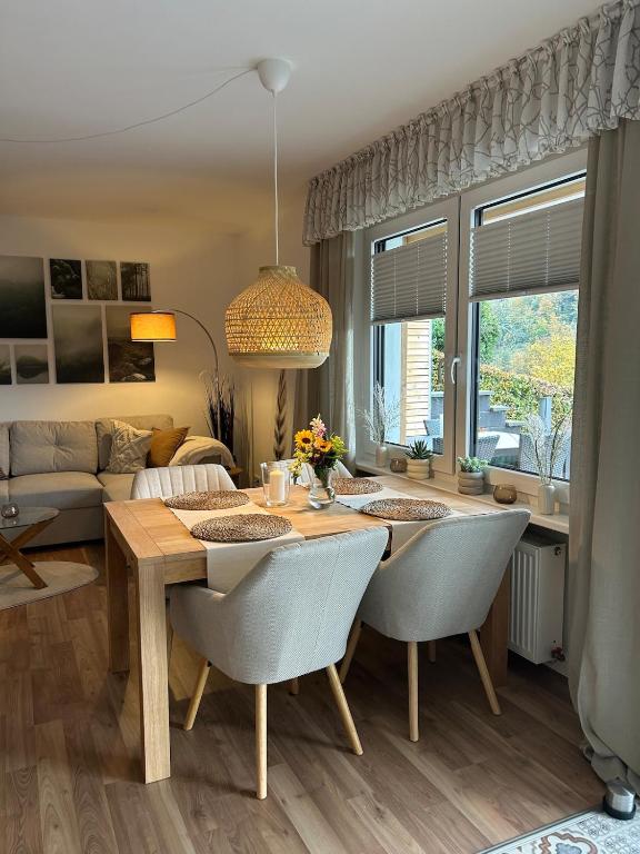 a living room with a dining table and a couch at Ferienwohnung Bergische Auszeit in Gummersbach