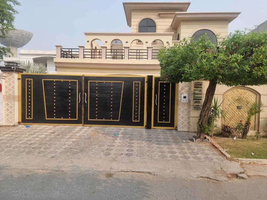 a house with a gate in front of it at Elegance Abounds in Qila Malla Singh