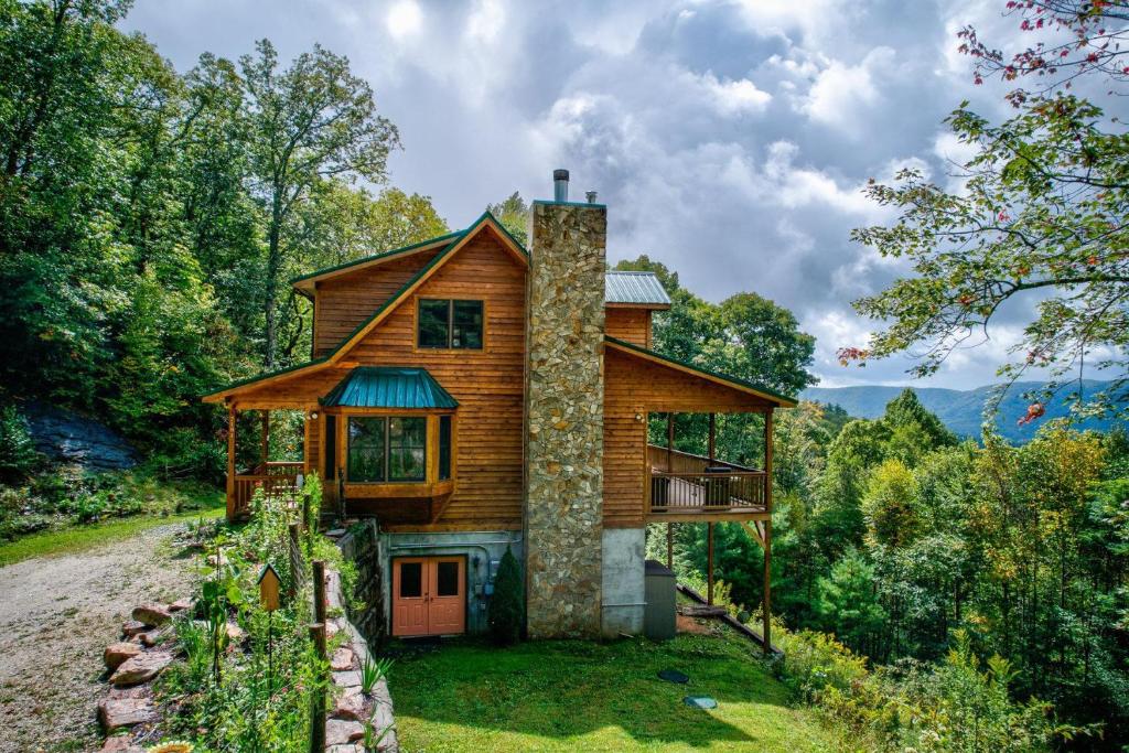a wooden house on a hill with trees at Peaceful View in Linville Falls