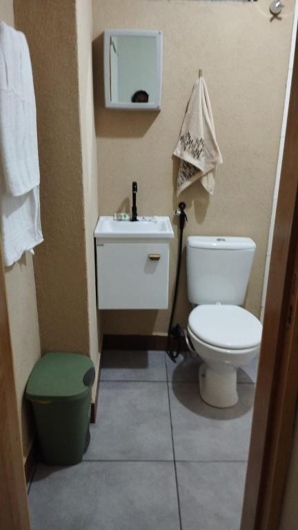 a bathroom with a toilet and a sink at Pousada Aconchego in Sidrolândia