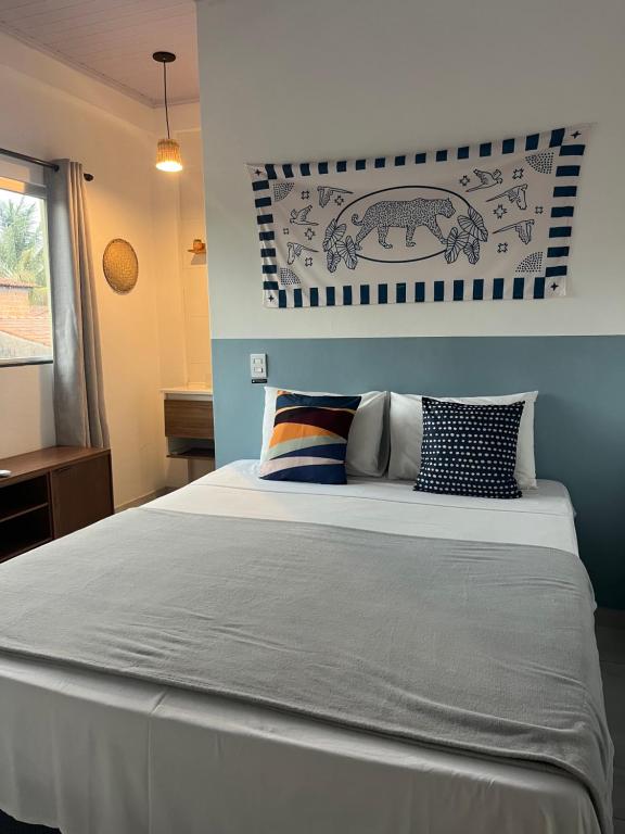 a bedroom with a large bed with blue walls at Suítes Preguiça in Sao Jorge