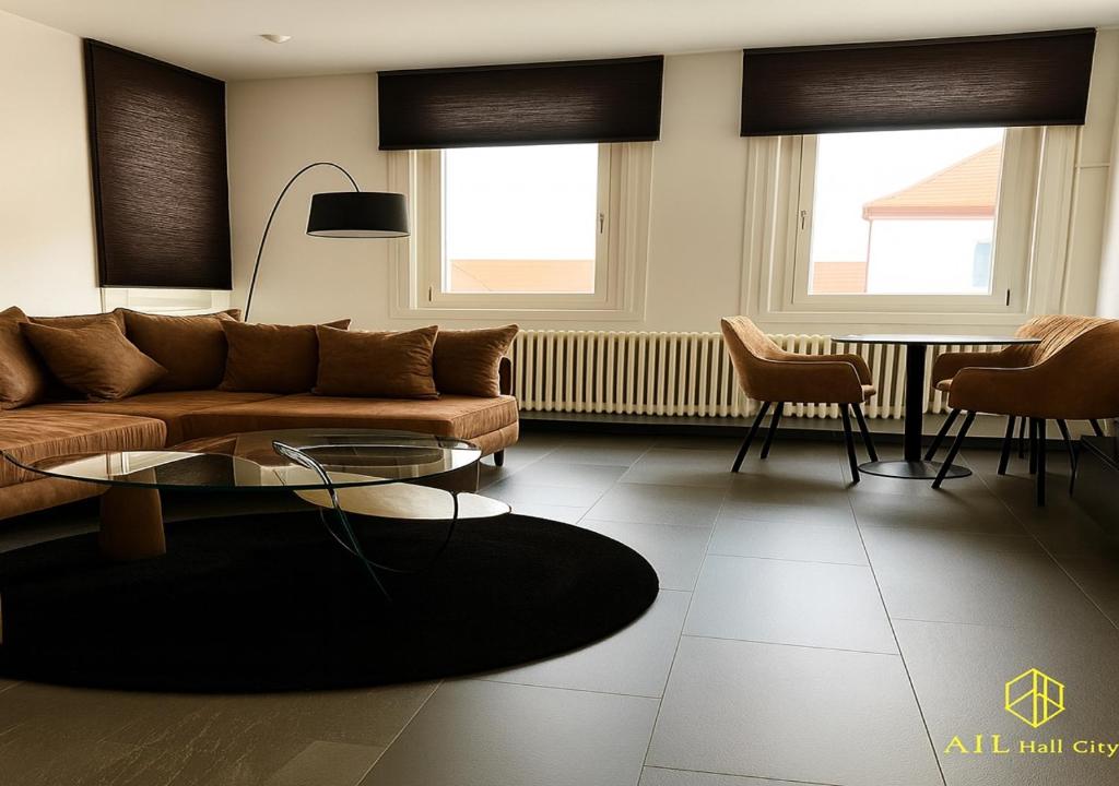 a living room with a couch and a table at AIL Hall City in Schwäbisch Hall