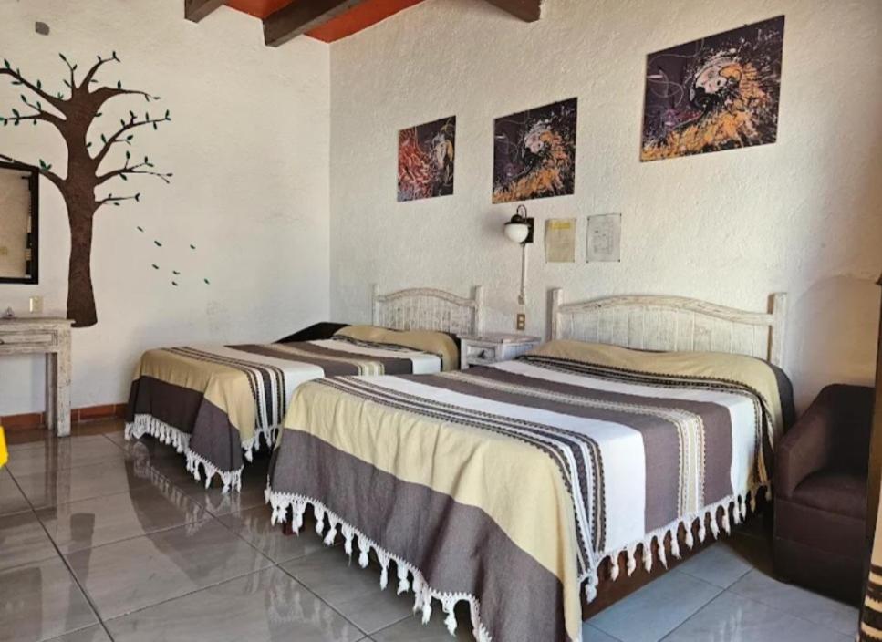 Postel nebo postele na pokoji v ubytování Hotel Los Remedios LUUM