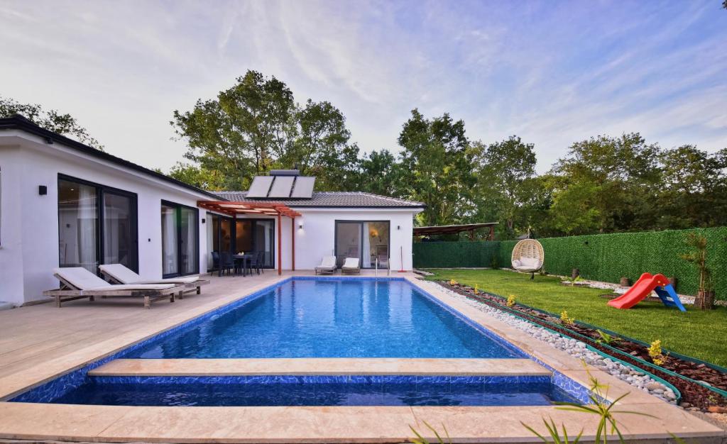 a swimming pool in the backyard of a house at Villa Matisse & Sierra - Kayaköy in Belen