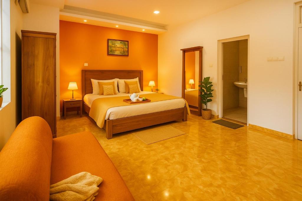 a hotel room with a bed and a couch at Spacious Eco House Malabe in Malabe