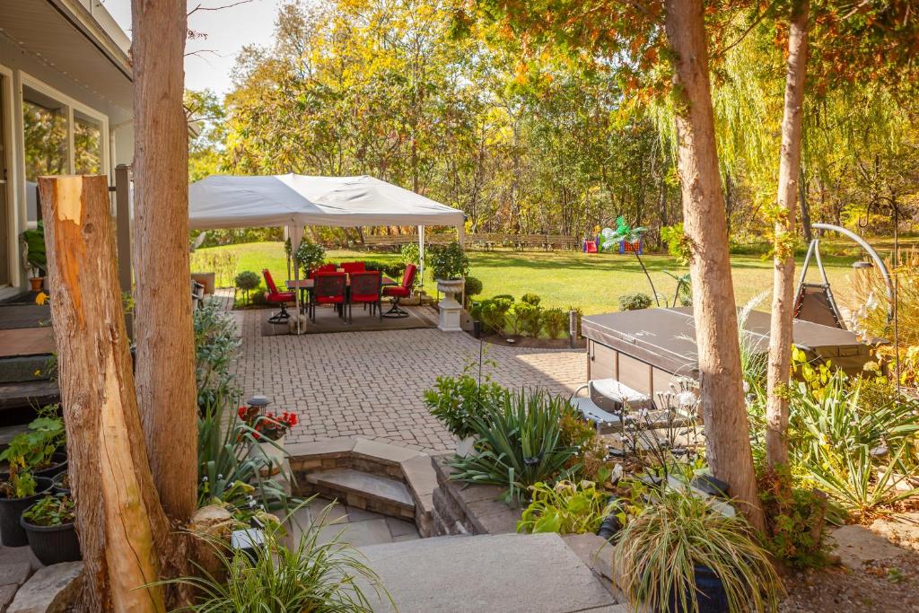a patio with a table and a white umbrella at Nature Oasis Mar Suite in Dundas