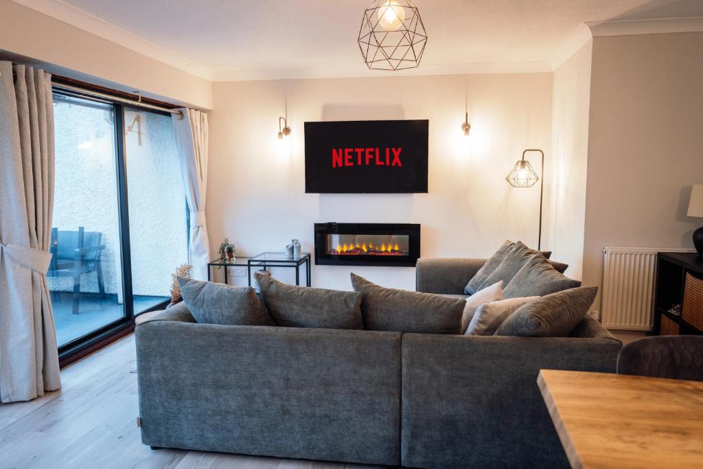 a living room with a couch and a fireplace at Bellman's Hideaway in Bowness-on-Windermere