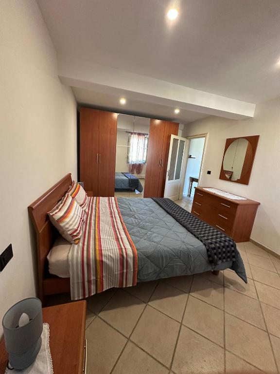 a bedroom with a bed and a dresser and a mirror at NidoPorcari in Porcari