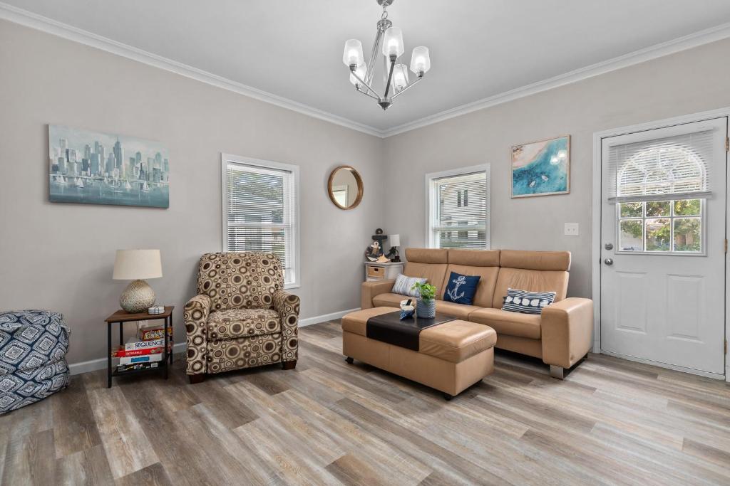 a living room with a couch and a chair at Central Oshkosh Stay - Walk to Lake and Downtown in Oshkosh