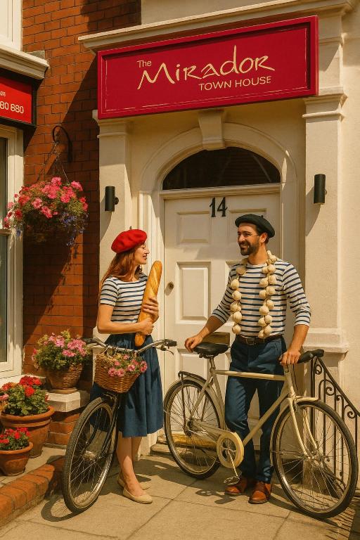 a man and a woman standing next to a bike at The Mirador Boutique Town House in Swansea
