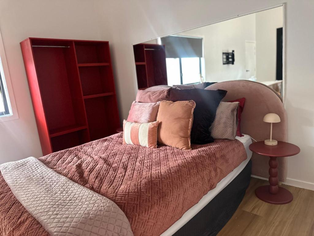 a bedroom with a bed with pillows on it at Aurora Self Contained Studio in Brisbane