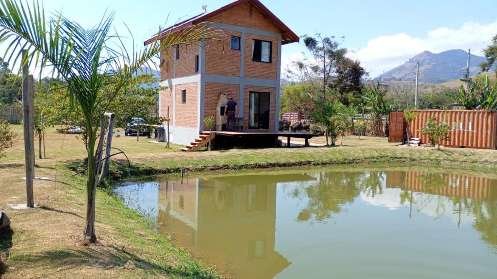 a house next to a body of water at Rancho das Estrelas in Gonçalves