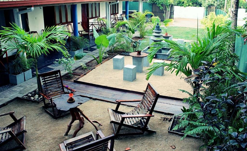 a garden with chairs and a table and a fountain at Surf Dine in Matara