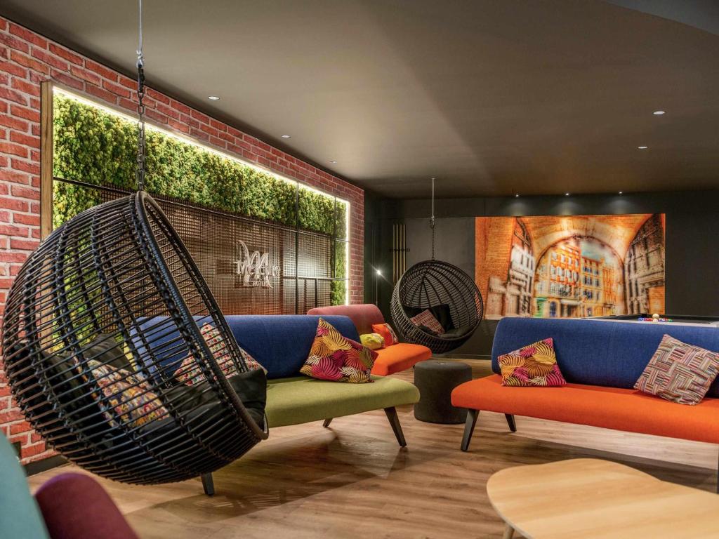 a living room with a couch and a swing at Hotel Mercure Toulouse Centre Compans in Toulouse