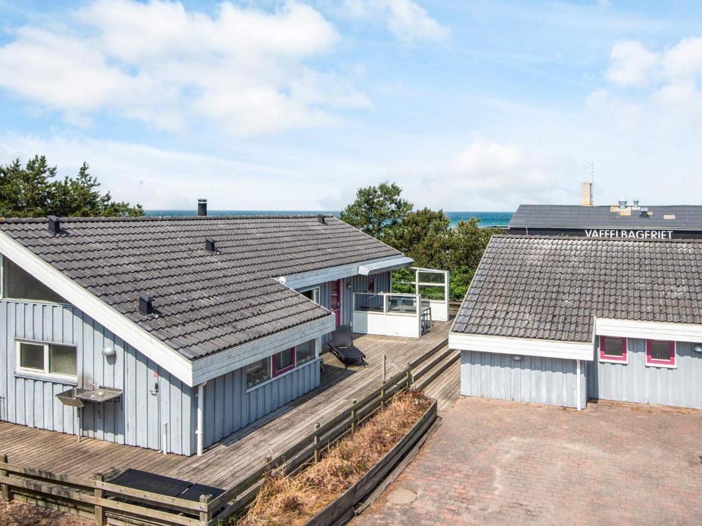 an image of two houses with roofs at 8 person holiday home in Glesborg in Fjellerup