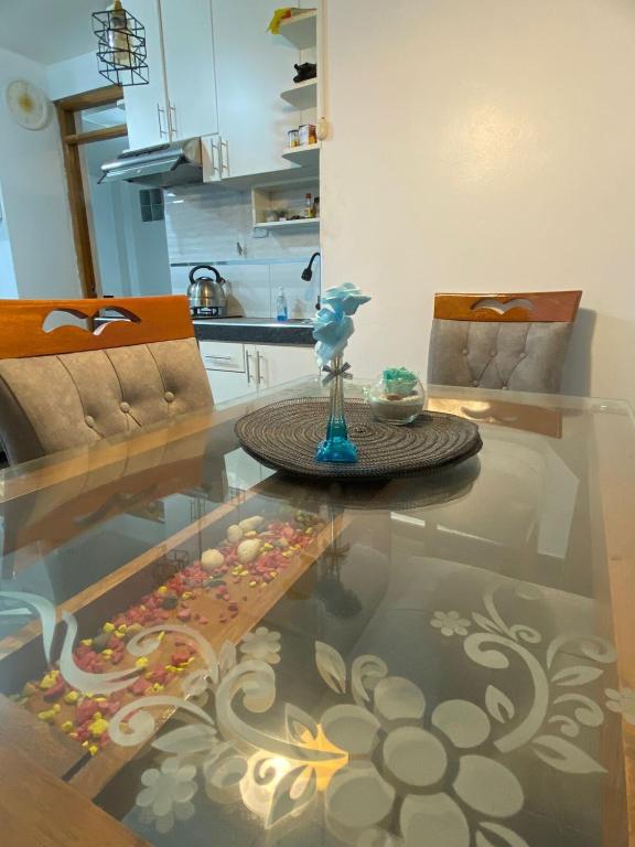 a living room with a glass table with a glass floor at Warm and Modern in the heart of the city in Huaraz