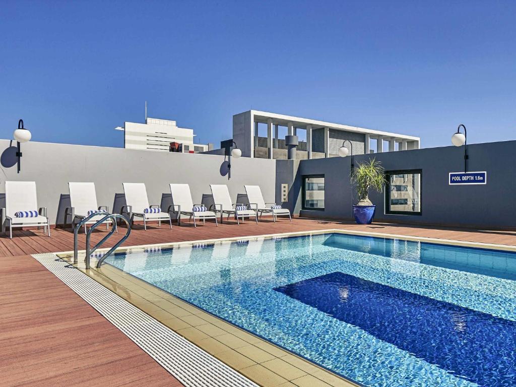 a swimming pool on the roof of a building at Mercure Perth in Perth