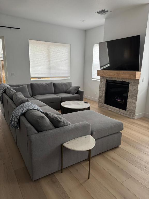 a living room with a couch and a fireplace at Mountain Pines Getaway in Flagstaff