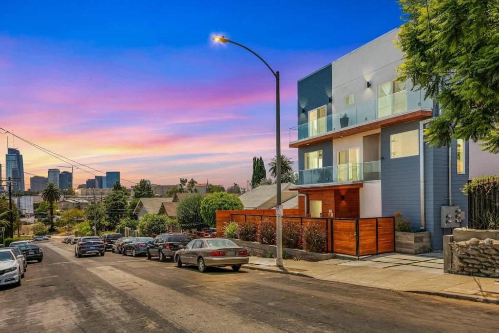 a street with cars parked in front of a building at Upscale LA Getaway Sleeps 8 with Free Parking in Los Angeles