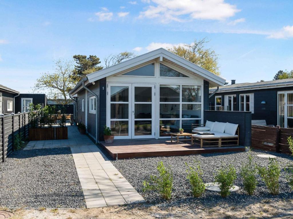 a house with a screened in porch with a patio at 5 star holiday home in Karrebæksminde in Karrebæksminde