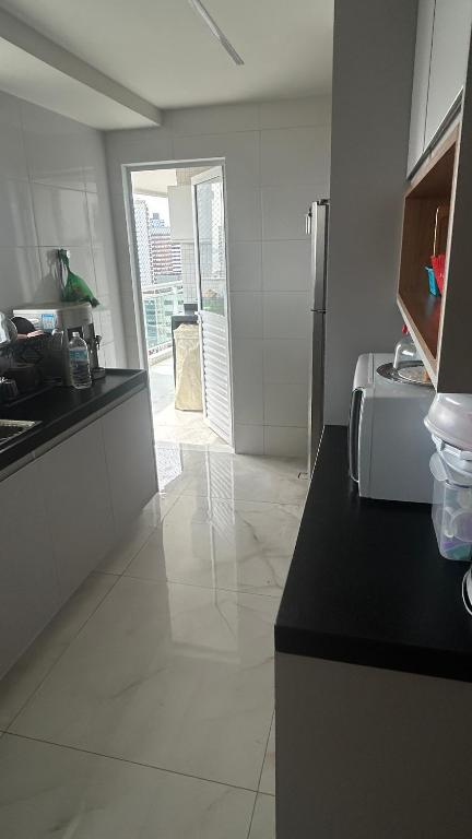 a kitchen with a counter top and a refrigerator at Edifício LISSE in Belém