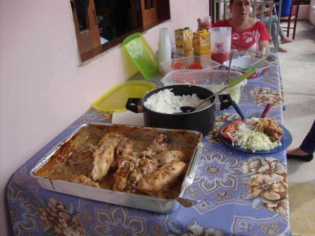 a table topped with a table with food on it at Pousadinha Mangabeiras II in São Mateus