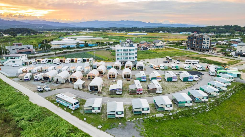 an aerial view of a parking lot with a bunch of trucks at Gangneung Base Camp Caravan Glamping in Hwapyeong-dong