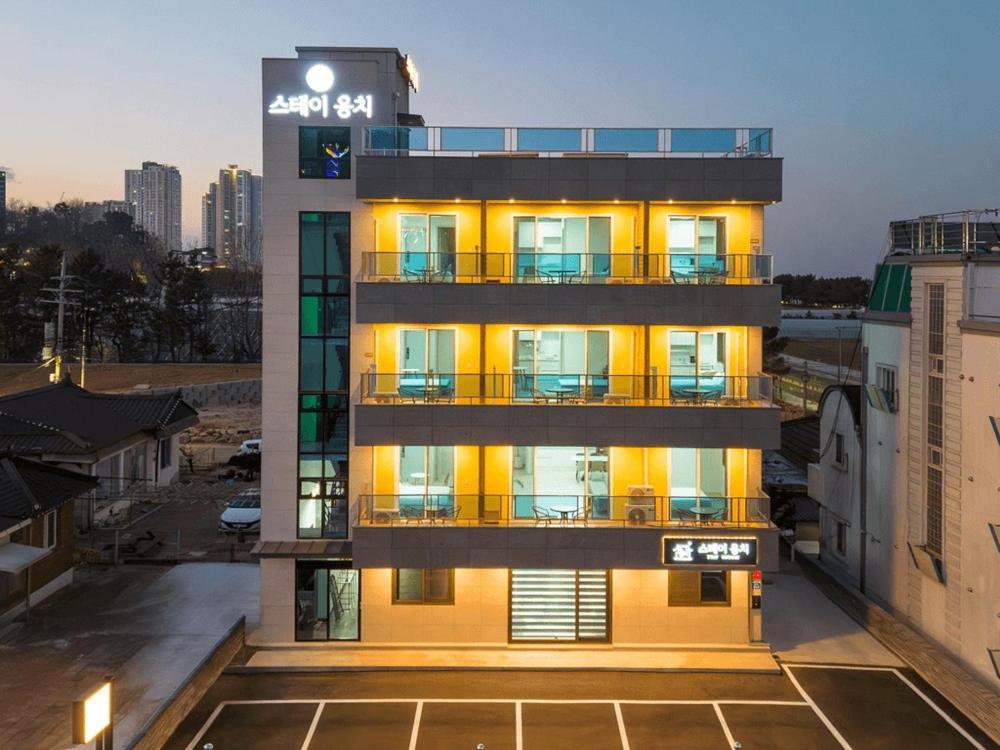 a tall building with a sign on top of it at Sokcho Stay Ongchi in Puwŏl-li
