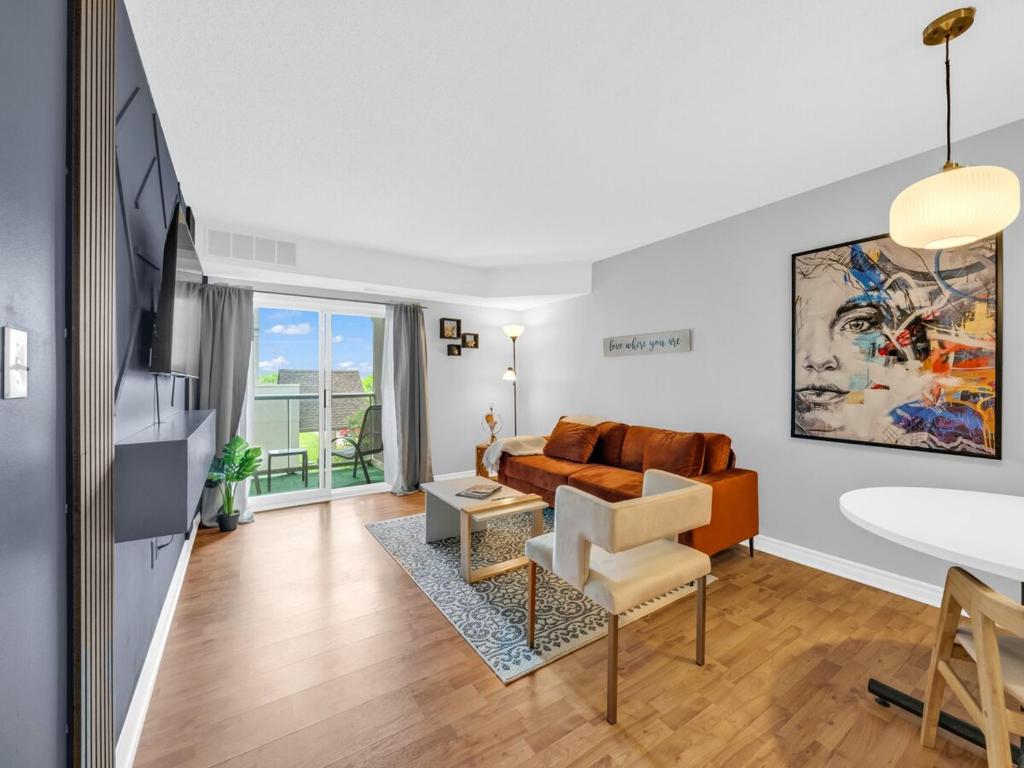 a living room with a couch and a table at Rare find by the Riverside in Windsor