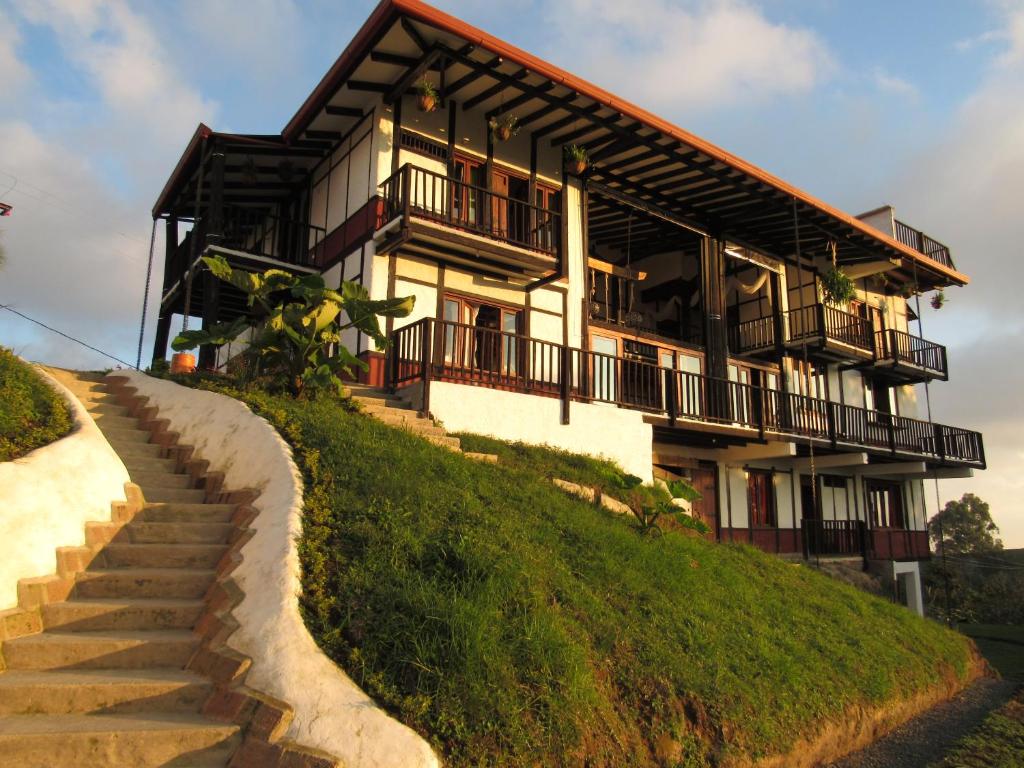 a house on a hill with stairs in front at Coffee Tree Boutique Hostel in Salento