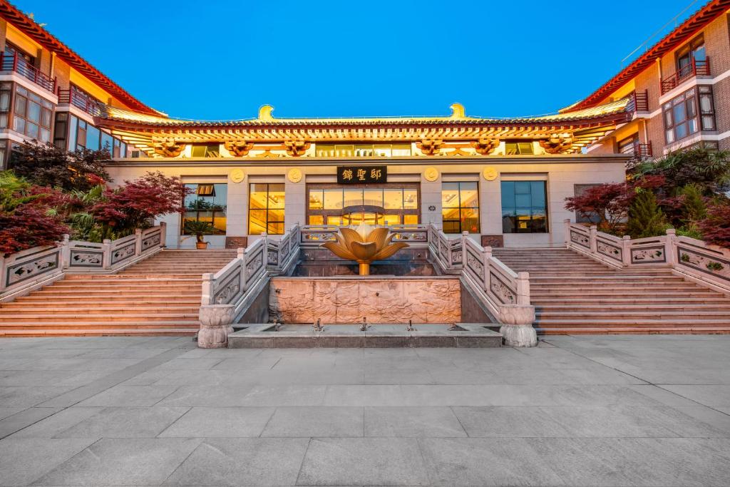 a large building with a fountain in front of it at Xi'an Xichen Hotel in Xi'an